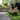Two men unrolling artificial grass on a garden