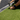 Person using a drill to secure artificial grass to a surface
